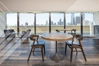 a room with a table and chairs and a view of a city